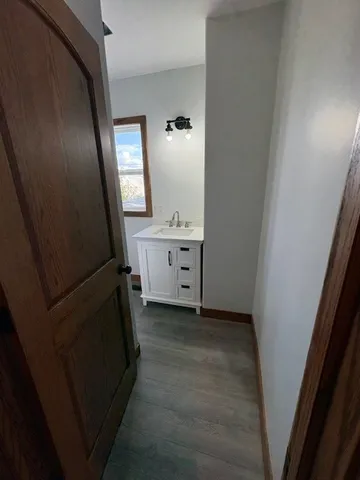 a bathroom with a sink a mirror and a vanity
