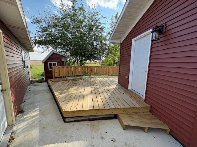 a view of backyard with a deck
