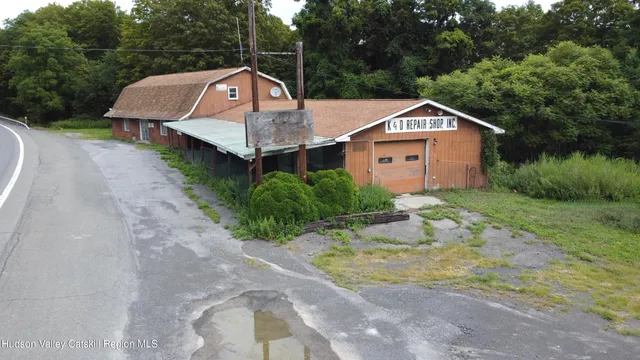 a aerial view of a house with a yard and large tree