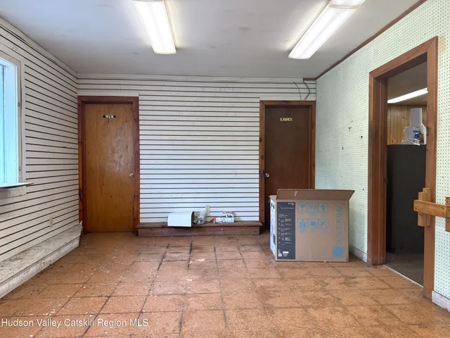 a view of a hallway with entryway and a window