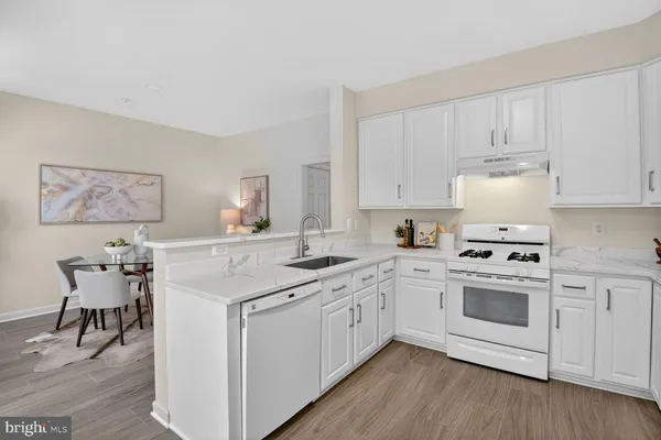 a kitchen with a white cabinets and chairs