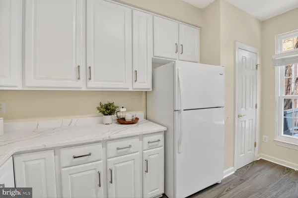 a white refrigerator freezer sitting inside of a kitchen