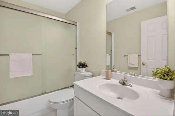 a bathroom with a sink toilet and mirror
