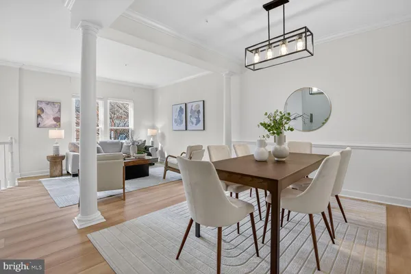 a view of a dining room with furniture wooden floor and a chandelier