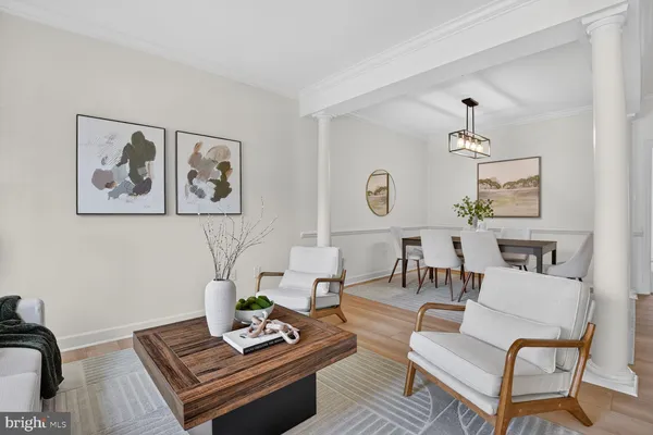 a living room with furniture and wall paintings