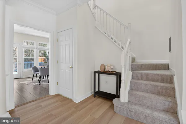 a view of entryway and hall with wooden floor