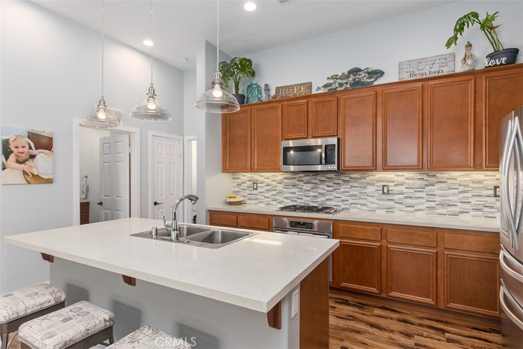 30307 Moon Star Circle Menifee, CA 92584 - Photo 22 of 53 a kitchen with a sink and cabinets