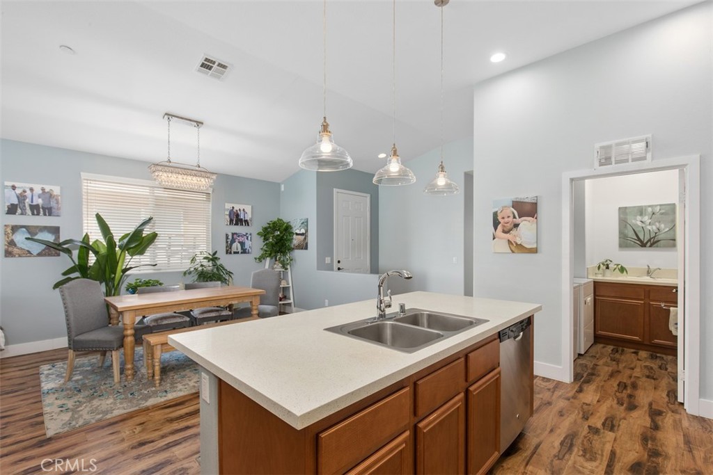 30307 Moon Star Circle Menifee, CA 92584 - Photo 24 of 53 a kitchen with a sink potted plant and wooden floor
