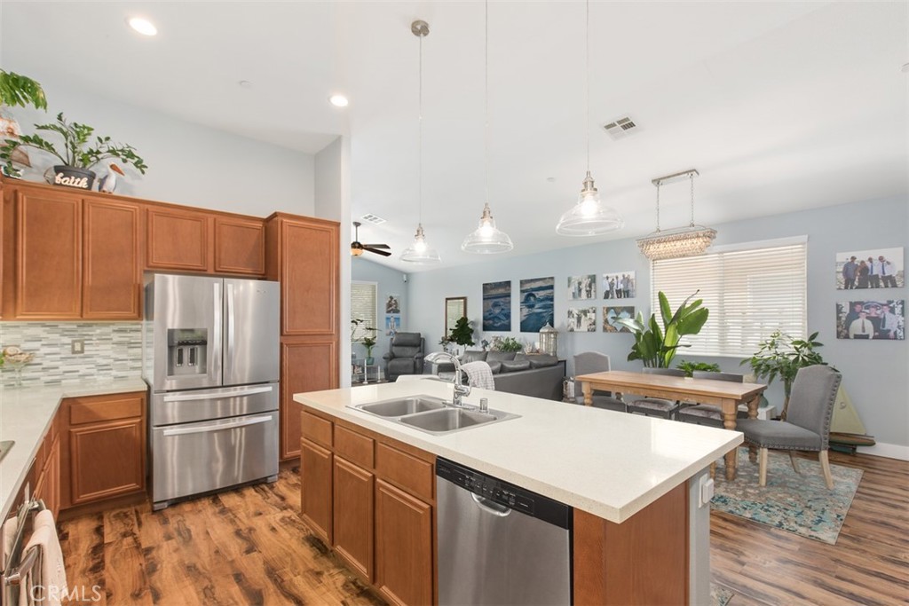 30307 Moon Star Circle Menifee, CA 92584 - Photo 25 of 53 a kitchen with stainless steel appliances a sink and a refrigerator