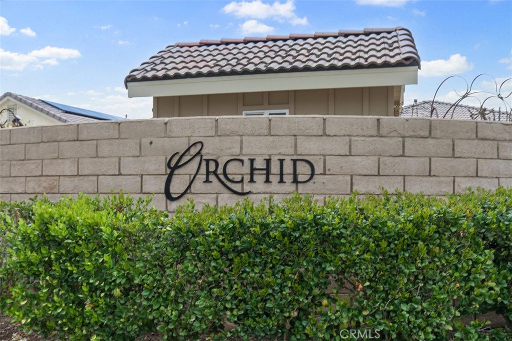 30307 Moon Star Circle Menifee, CA 92584 - Photo 51 of 53 a view of a brick wall with plants and wooden fence
