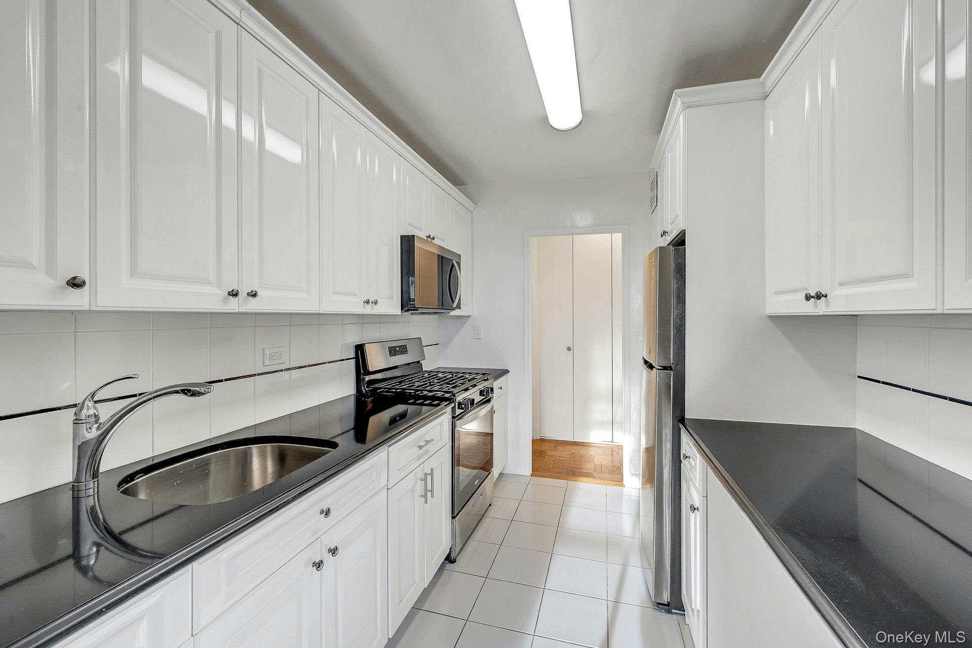 615 Palmer Road, Unit 1004 Yonkers, NY 10701 - Photo 1 of 21 Updated galley kitchen with stainless steel appliances. Pantry and closet storage at the end of the kitchen.