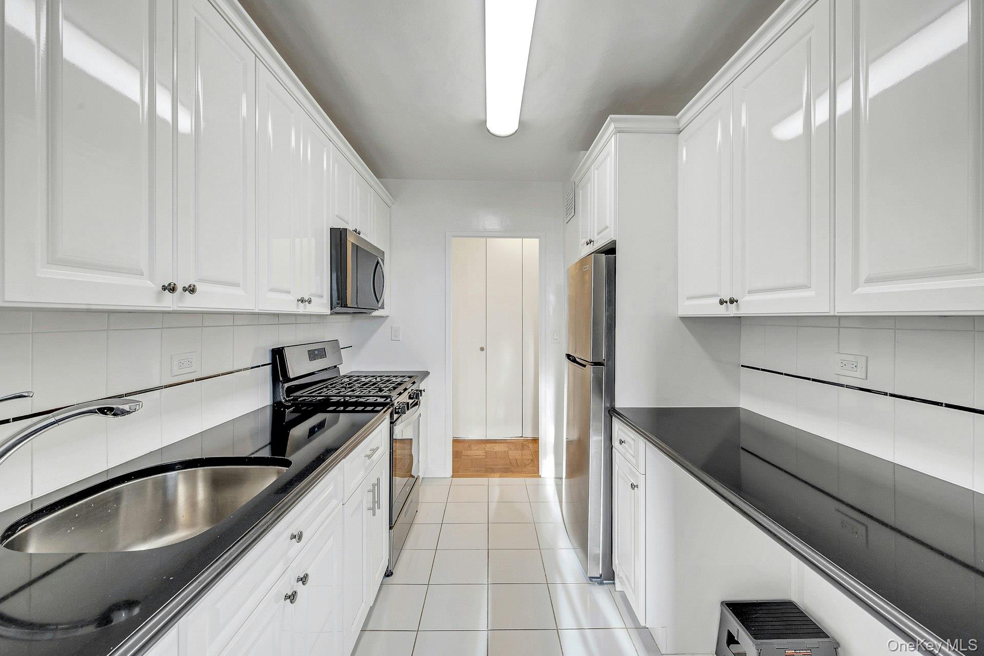 615 Palmer Road, Unit 1004 Yonkers, NY 10701 - Photo 2 of 21 Another view of the bright, crisp white galley kitchen.