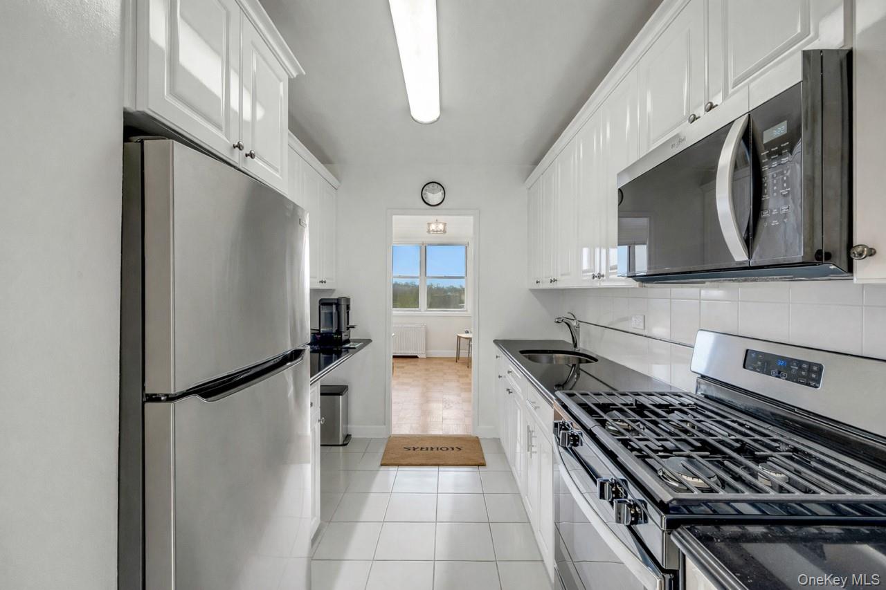 615 Palmer Road, Unit 1004 Yonkers, NY 10701 - Photo 3 of 21 Opposite view of kitchen showing dining area at end of photo.