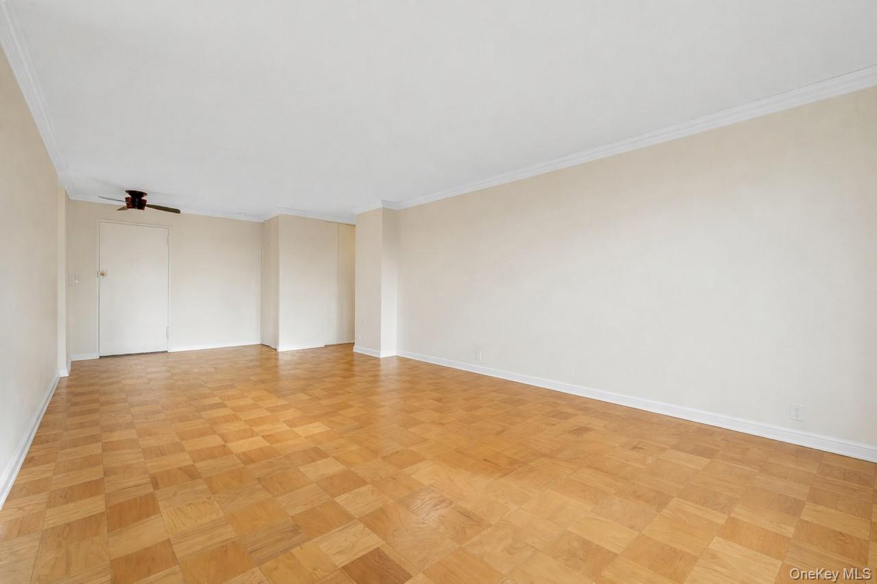 615 Palmer Road, Unit 1004 Yonkers, NY 10701 - Photo 10 of 21 Opposing view of the oversized living room showing a deep coat closet to the right of the entry door with hall to the right leading to additional deep closet space, bedroom, and bathroom.
