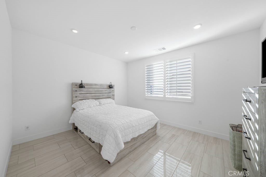 3040 Cove Street Rancho Mission Viejo, CA 92694 - Photo 16 of 44 a bedroom with a bed and a window