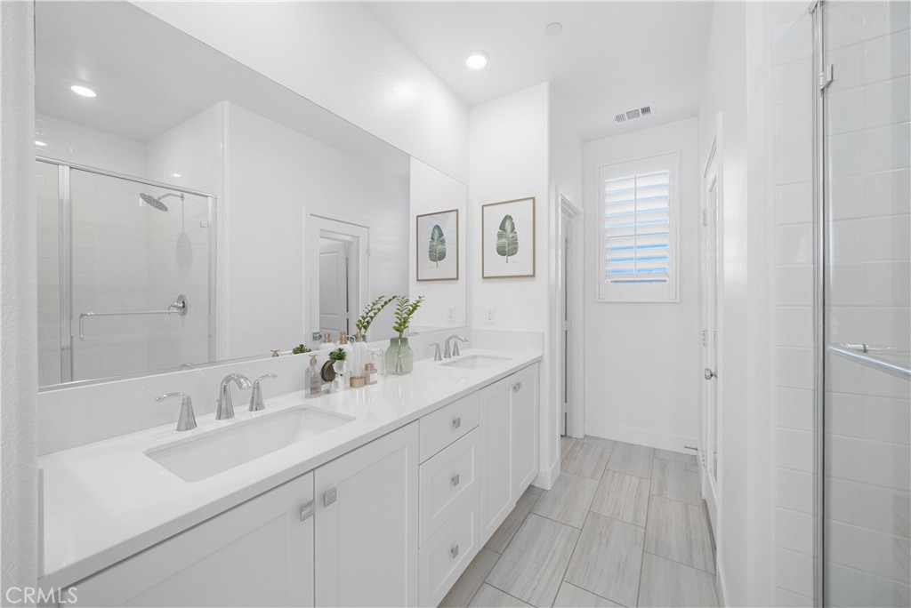 3040 Cove Street Rancho Mission Viejo, CA 92694 - Photo 17 of 44 a spacious bathroom with a double vanity sink mirror and