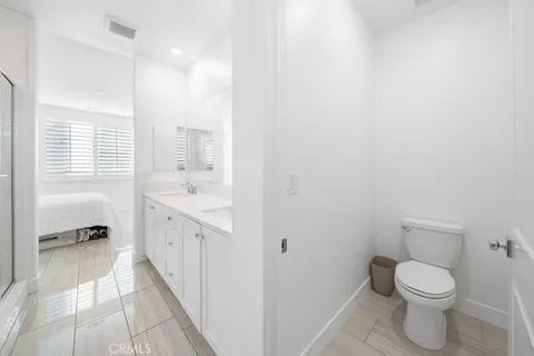 a bathroom with a sink a toilet and a shower