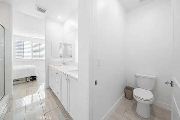 a bathroom with a sink a toilet and a shower