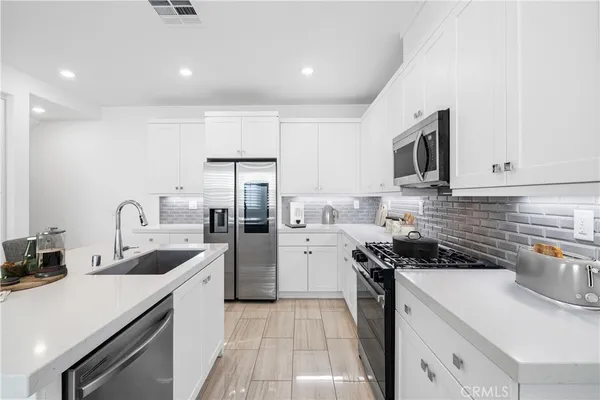 a kitchen with a sink a stove and refrigerator