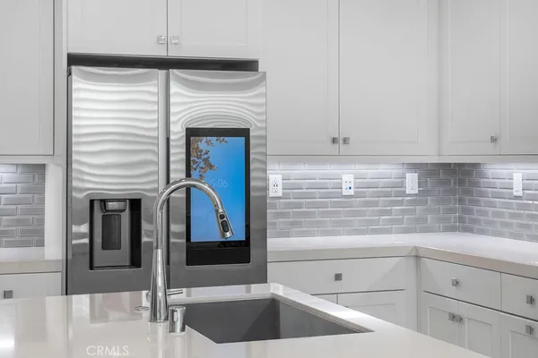 a kitchen with granite countertop white cabinets and white appliances