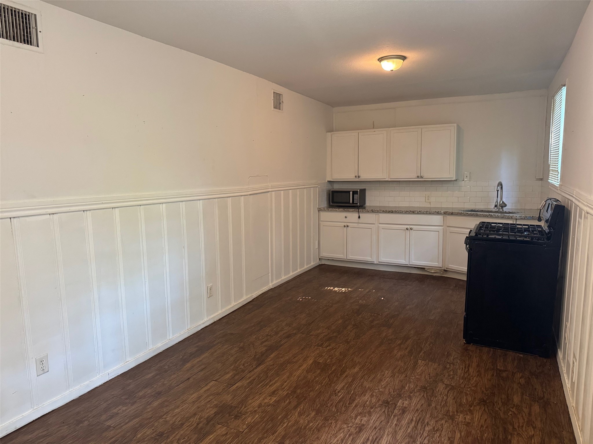 1104 Maple Street, Unit 2 La Marque, TX 77568 - Photo 13 of 16 a kitchen with granite countertop a sink and cabinets