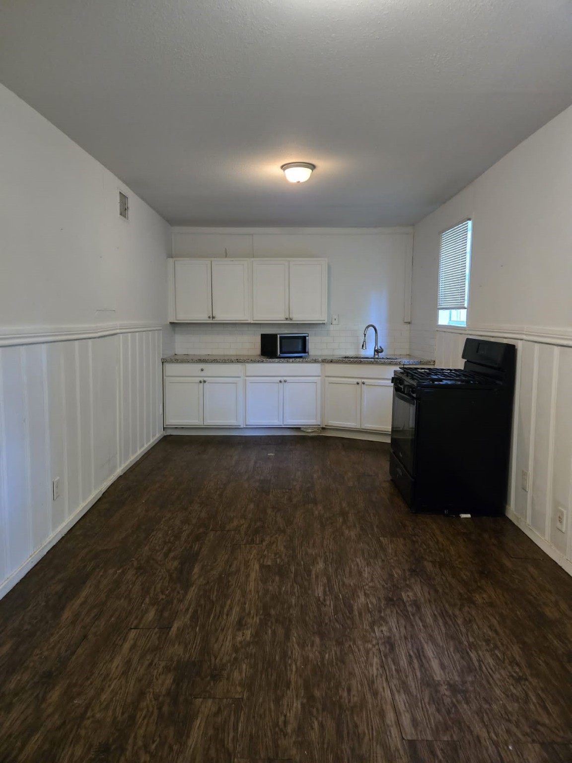 1104 Maple Street, Unit 2 La Marque, TX 77568 - Photo 14 of 16 a kitchen with granite countertop a refrigerator and a stove top oven