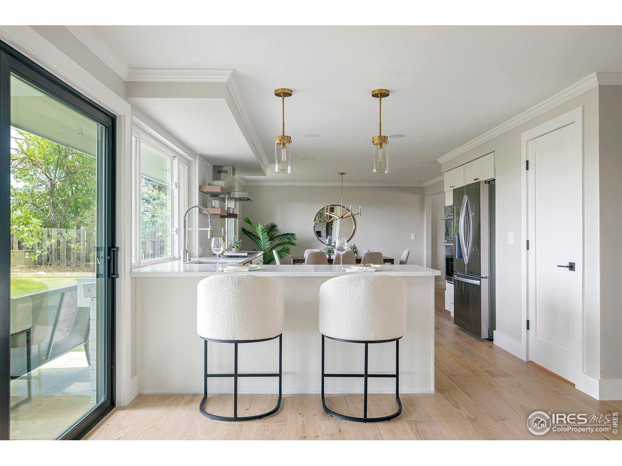 6978 Carter Trail Boulder, CO 80301 - Photo 11 of 39 a white kitchen with a sink a counter top space stainless steel appliances and cabinets