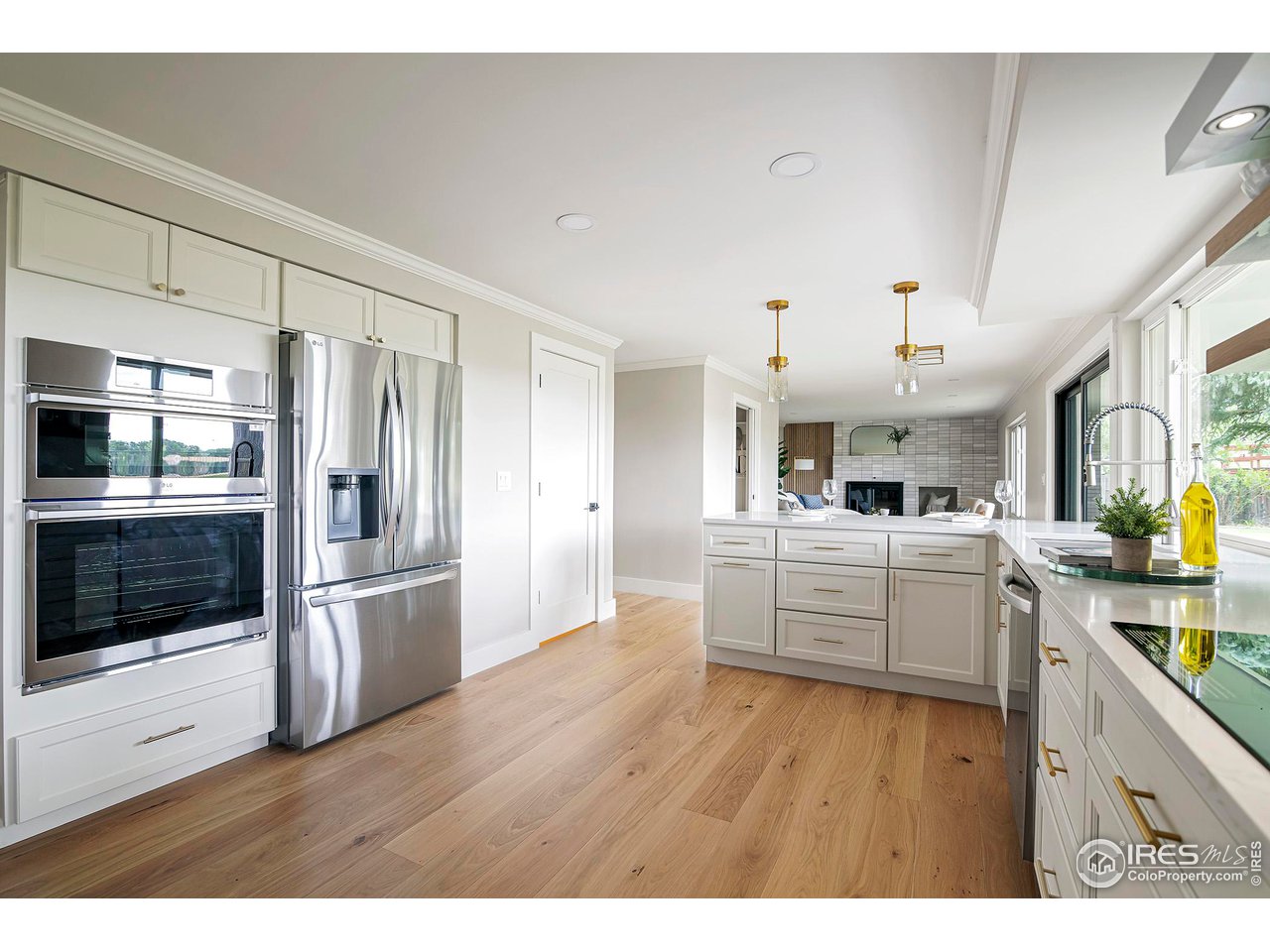 6978 Carter Trail Boulder, CO 80301 - Photo 13 of 39 a kitchen with stainless steel appliances kitchen island wooden floors and refrigerator