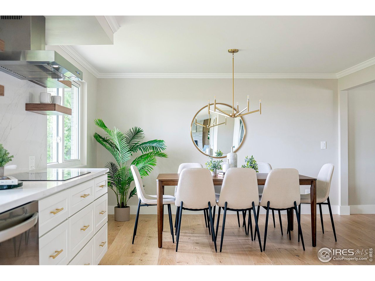 6978 Carter Trail Boulder, CO 80301 - Photo 6 of 39 a dining room with furniture a potted plant and a chandelier