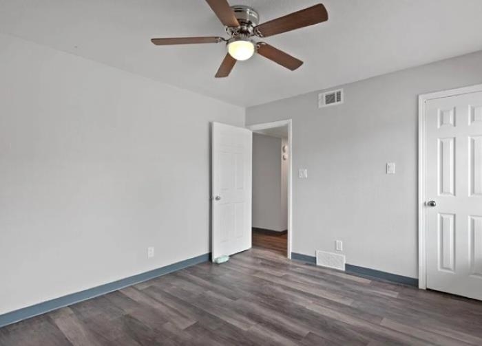 1283 East Raines Road Memphis, TN 38116 - Photo 9 of 23 an empty room with wooden floor ceiling fan and window