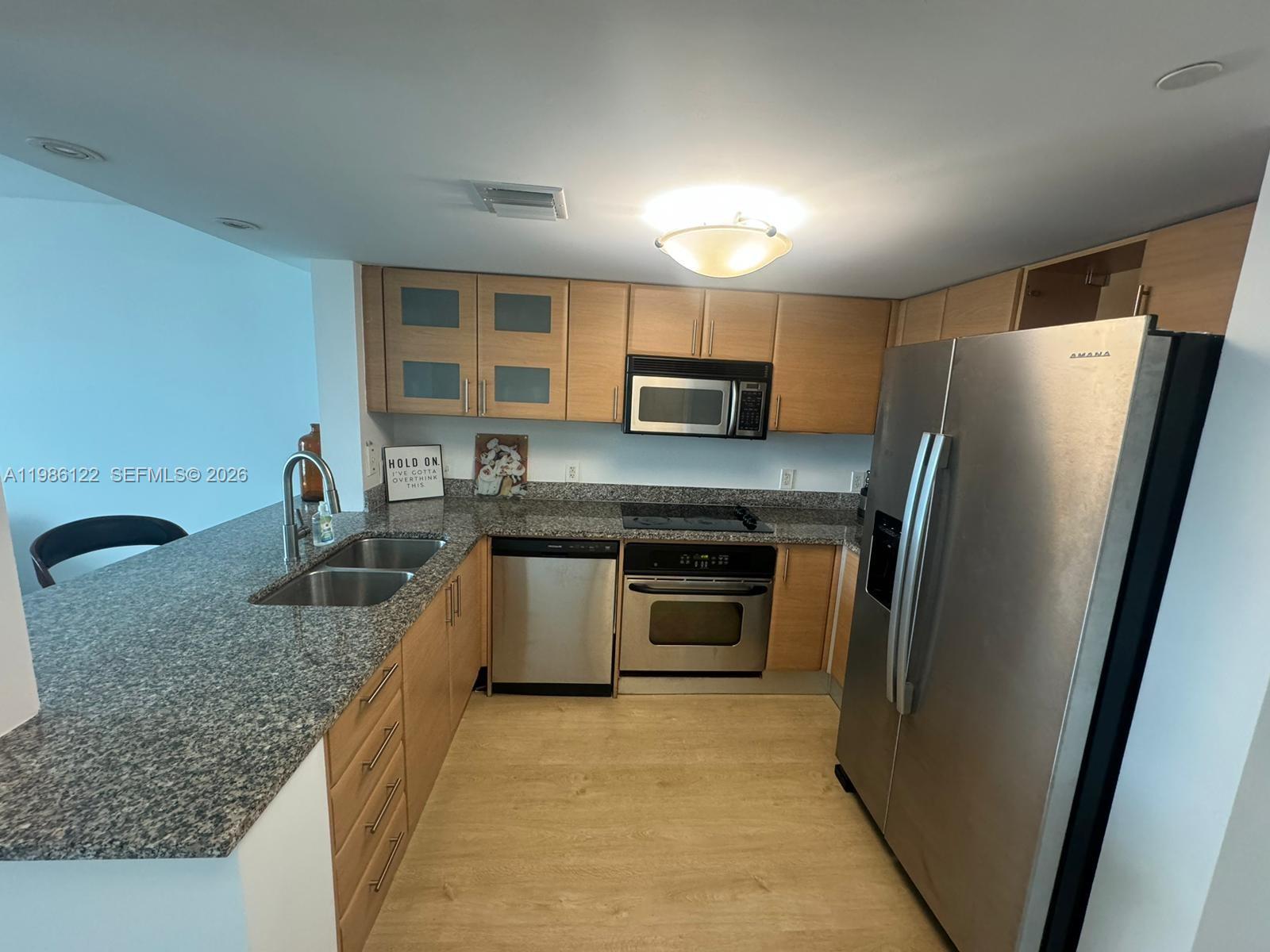 2101 Brickell Avenue, Unit 2102 Miami, FL 33129 - Photo 2 of 29 a kitchen with stainless steel appliances granite countertop a refrigerator stove and sink
