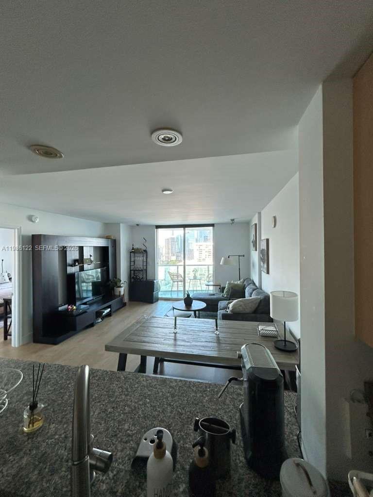 2101 Brickell Avenue, Unit 2102 Miami, FL 33129 - Photo 28 of 29 a living room with furniture and a large window