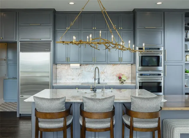 a kitchen with a table chairs refrigerator and cabinets