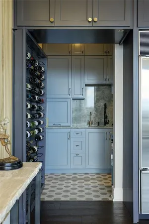 a kitchen with kitchen island granite countertop a sink cabinets and wooden floor