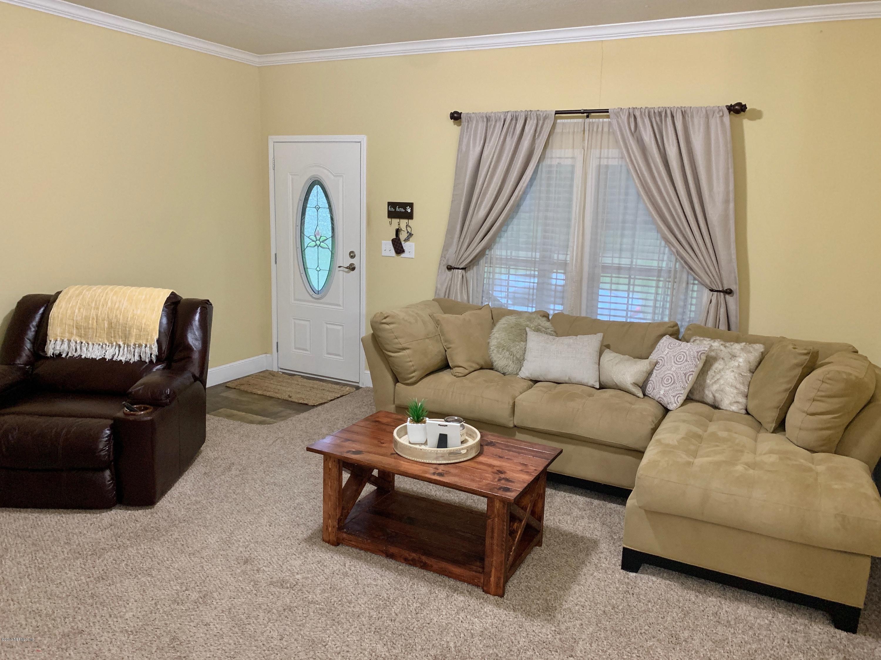14227 Southwest 151st Avenue Brooker, FL 32622 - Photo 3 of 9 a living room with furniture and a window