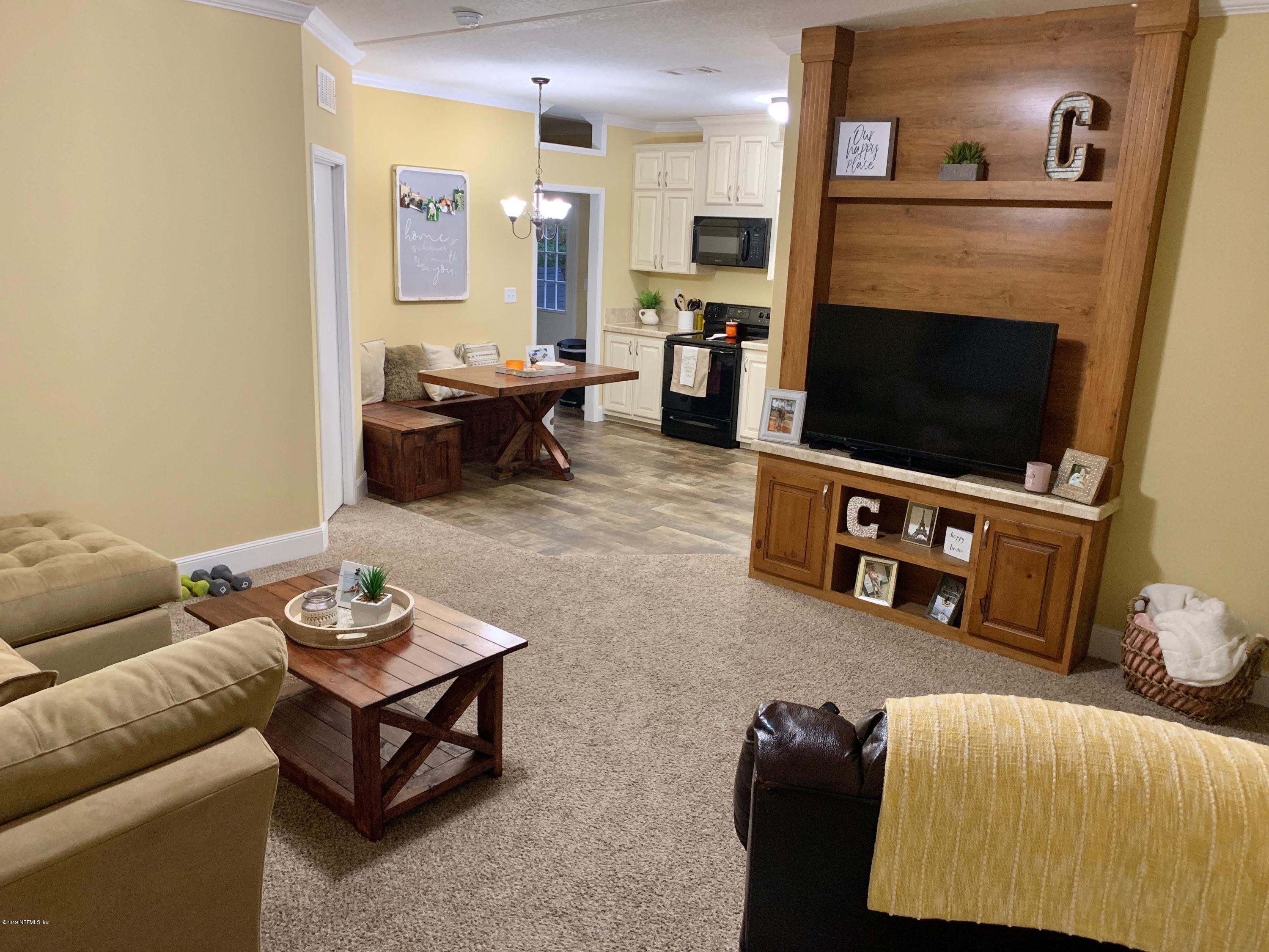 14227 Southwest 151st Avenue Brooker, FL 32622 - Photo 5 of 9 a living room with furniture and a fireplace