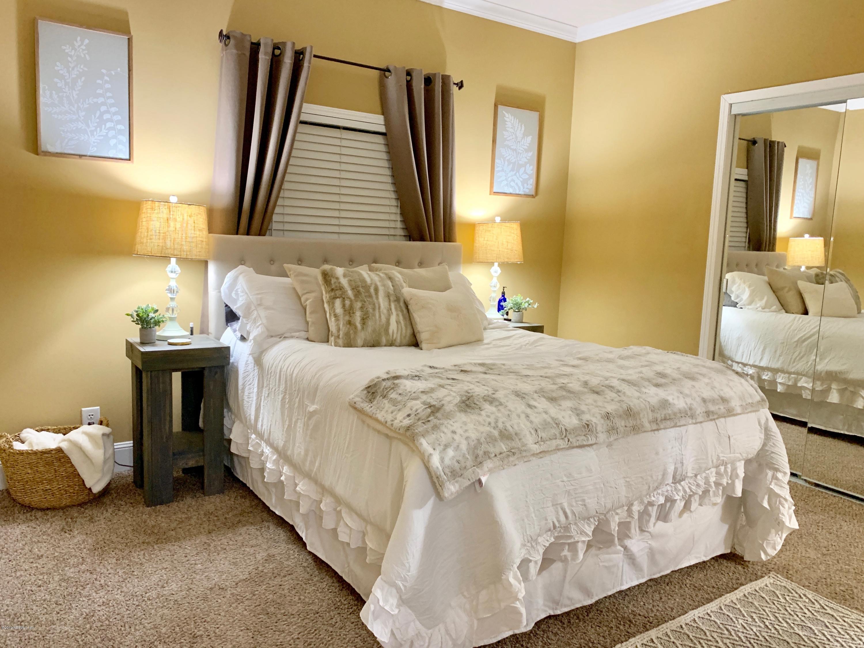 14227 Southwest 151st Avenue Brooker, FL 32622 - Photo 7 of 9 a bedroom with a bed and a couch