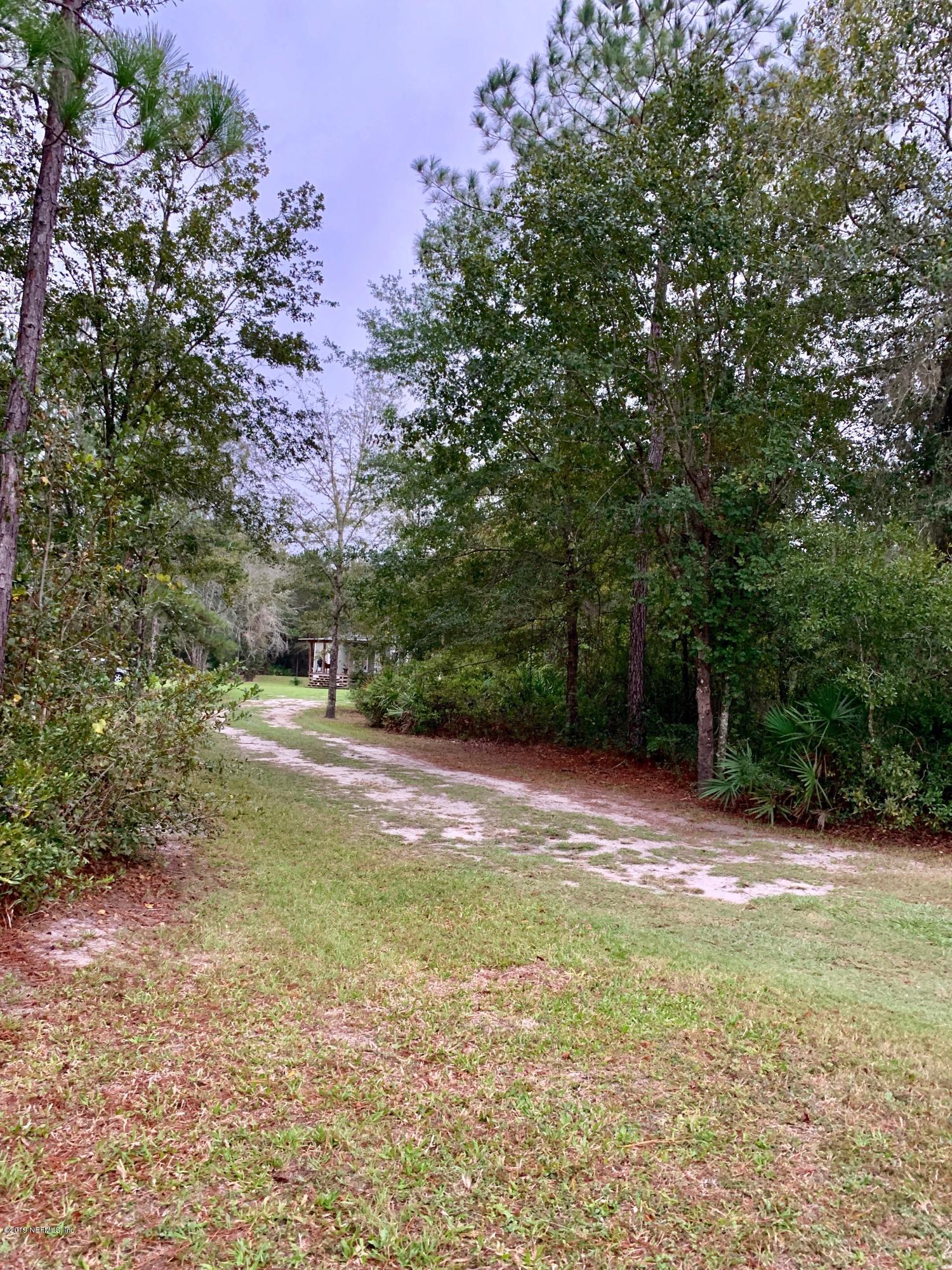 14227 Southwest 151st Avenue Brooker, FL 32622 - Photo 8 of 9 a view of a yard with a tree