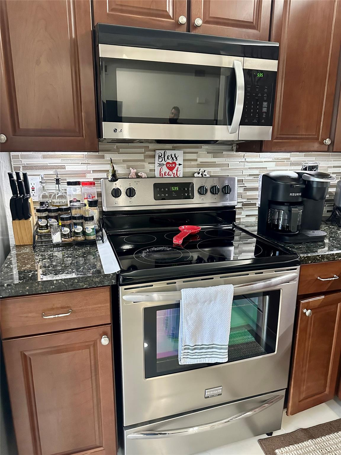 18814 Cloud Lake Circle Boca Raton, FL 33496 - Photo 14 of 19 a kitchen with stainless steel appliances granite countertop a stove and a microwave