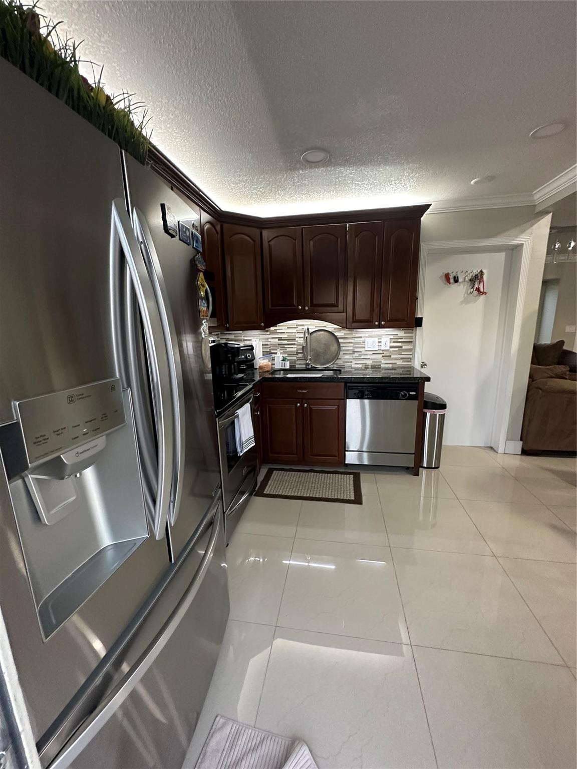 18814 Cloud Lake Circle Boca Raton, FL 33496 - Photo 18 of 19 a view of kitchen with refrigerator and fireplace