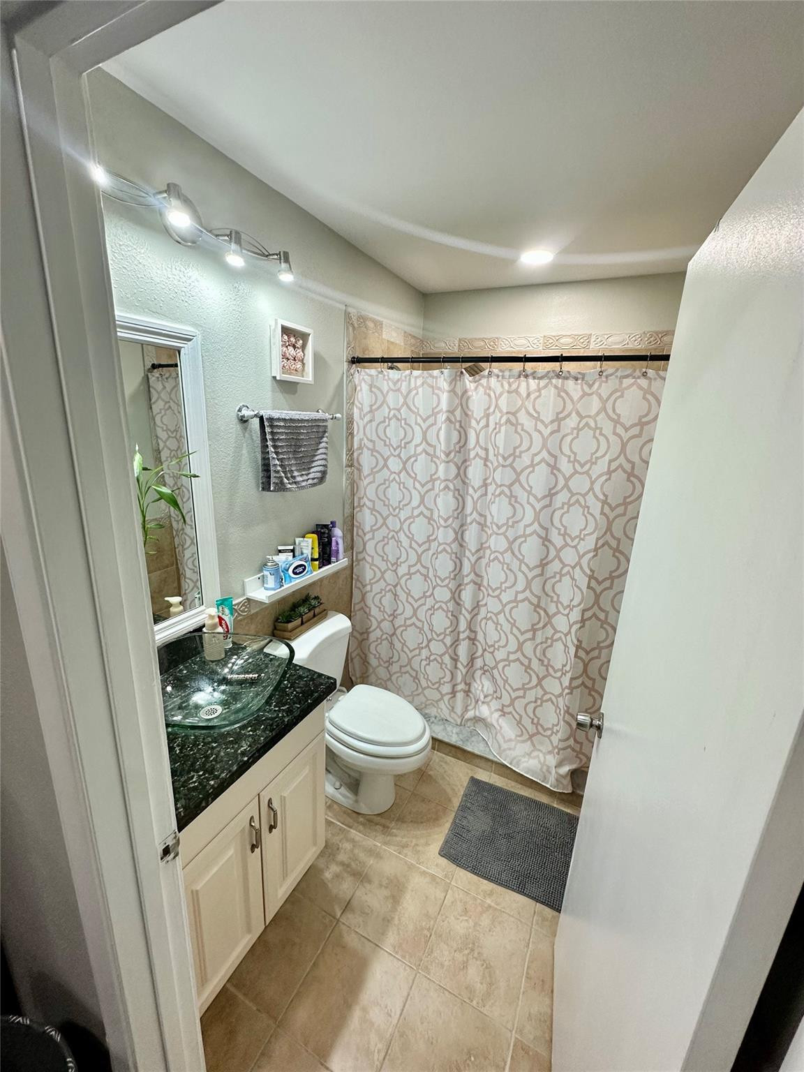 18814 Cloud Lake Circle Boca Raton, FL 33496 - Photo 9 of 19 a bathroom with a granite countertop sink toilet and shower