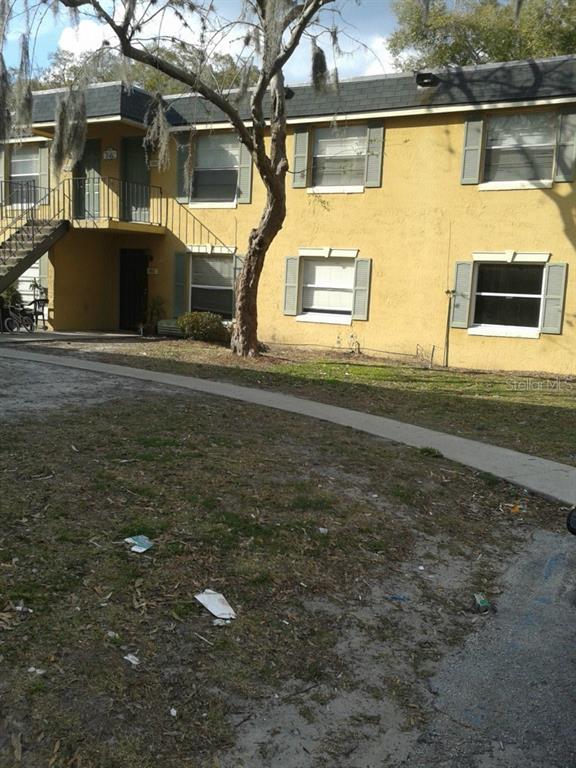7662 Forest City Road, Unit 122 Orlando, FL 32810 - Photo 1 of 1 a front view of a house with a yard