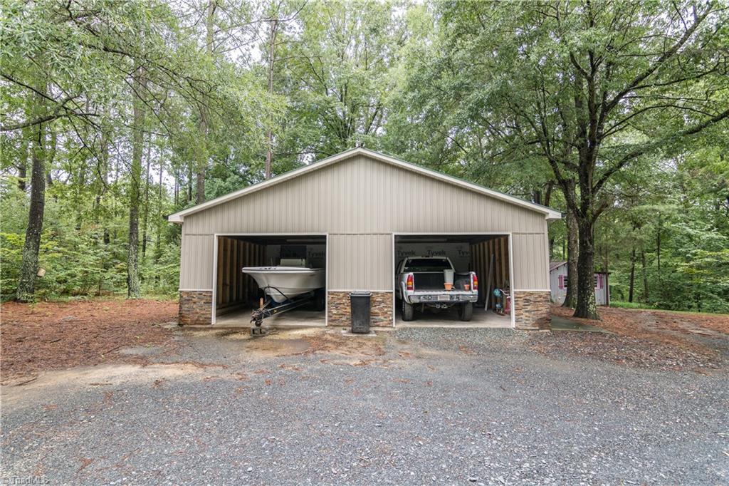 Detached oversized 2 car garage with rock detail just steps from the house. 
