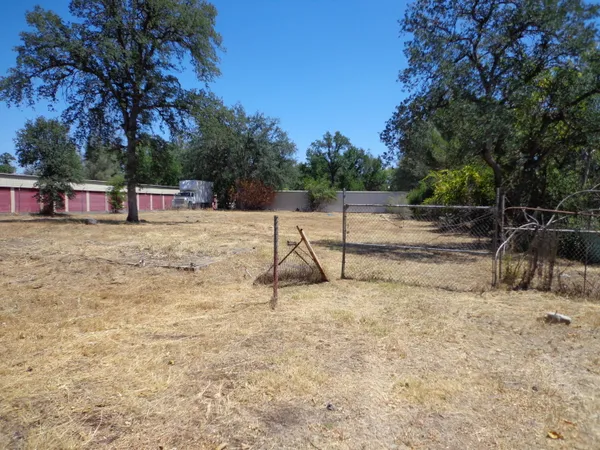 a backyard of a house with large trees