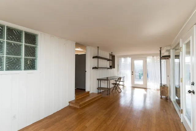 a view of a kitchen with furniture and wooden floor