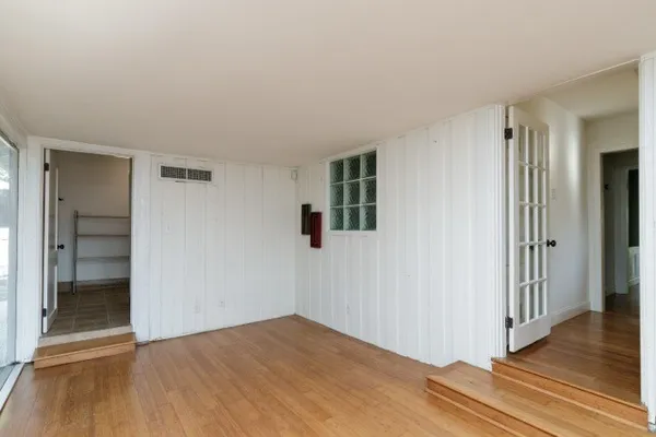 wooden floor in an empty room with a window