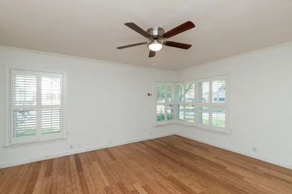 a view of a room with wooden floor staircase and a chandelier