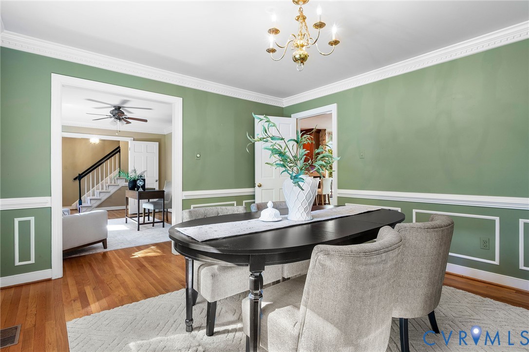 15010 Walnut Bend Road Midlothian, VA 23112 - Photo 15 of 35 a view of a dining room with furniture and wooden floor