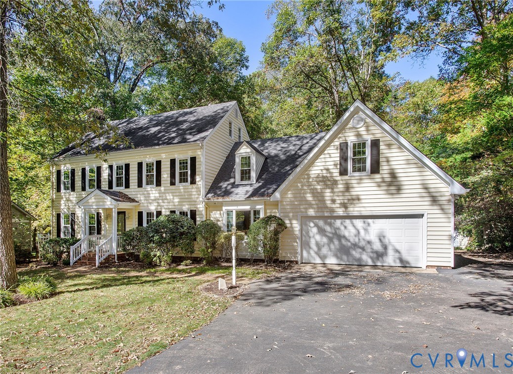 15010 Walnut Bend Road Midlothian, VA 23112 - Photo 2 of 35 a view of a white house with large windows and a small yard