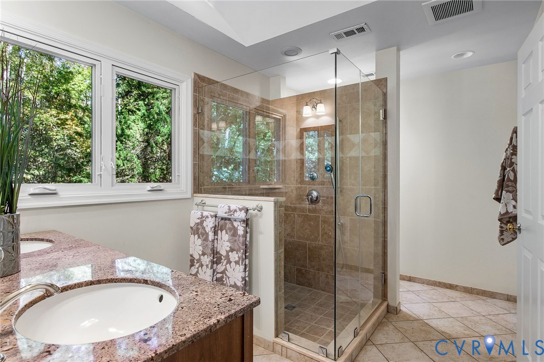 15010 Walnut Bend Road Midlothian, VA 23112 - Photo 23 of 35 a bathroom with a granite countertop shower a mirror and a sink